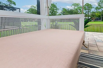 Overhead view of the Debbie swing bed blush mattress cushion and white lattice side rails