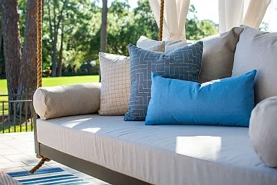 White Crib Sized Swing Bed with Sunbrella cushions and Outdoor Curtains and Jute Rug